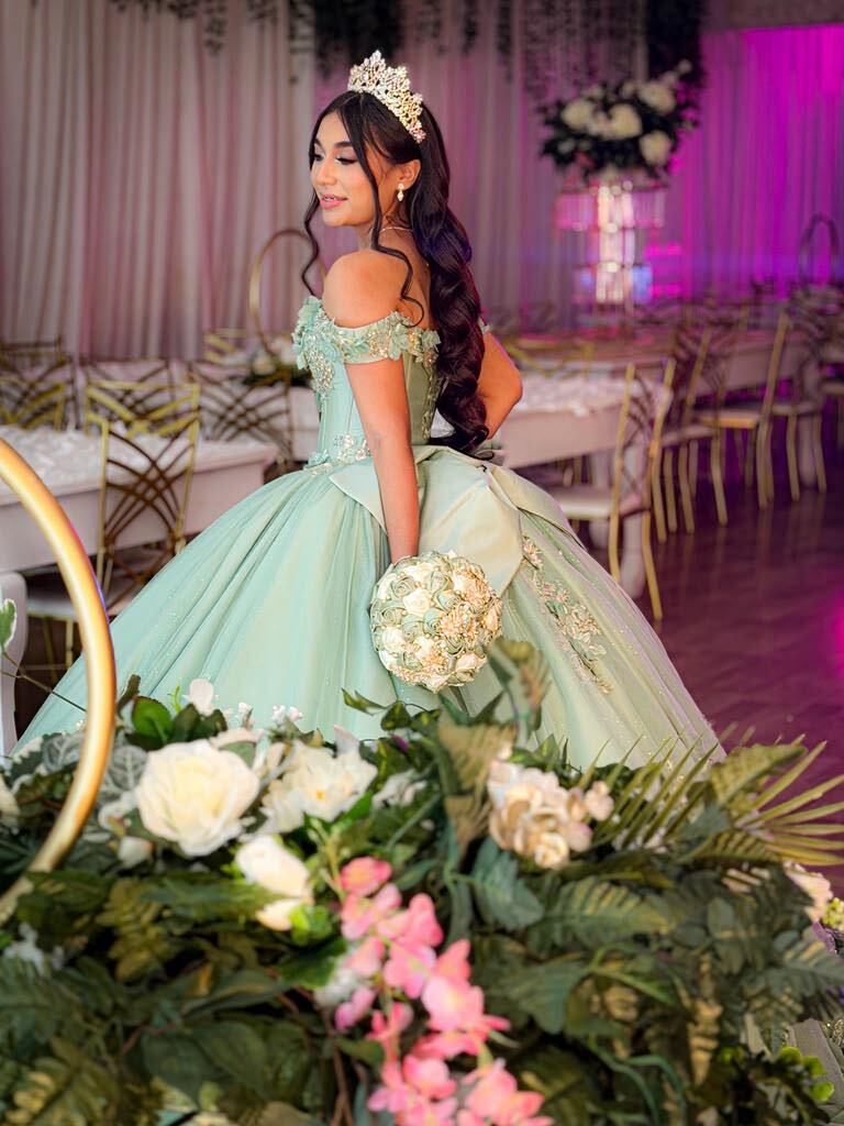 A quinceañera in the salon beneath the lights